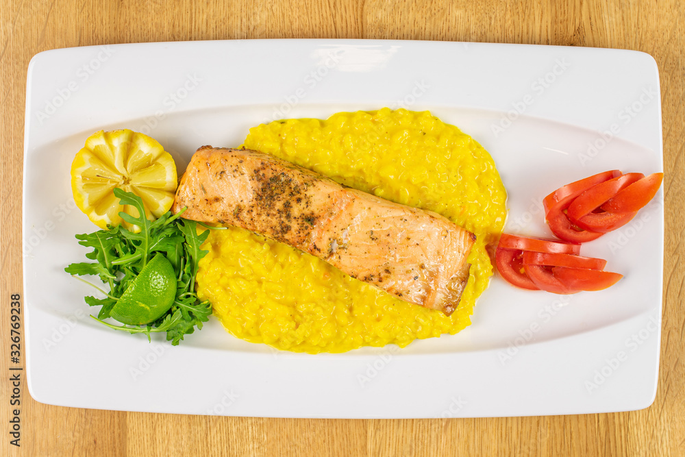 Beautiful grilled salmon with potato mash on white rectangular ceramic plate flatlay on lacquered wood Beautiful grilled salmon with potato mash on white rectangular ceramic plate flatlay on lacquered wood