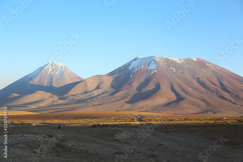 Bolivia highlands, Andes. Mountains with snow in the peaks under a clear blue sky. High altitude desert of Bolivia.