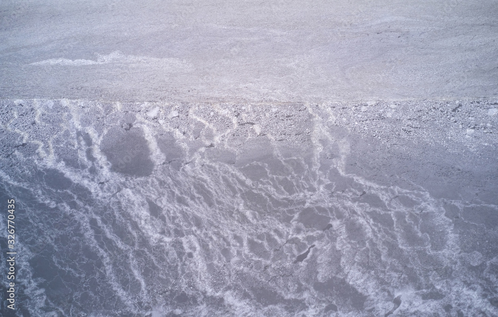 Obraz premium Ice texture on shore of river