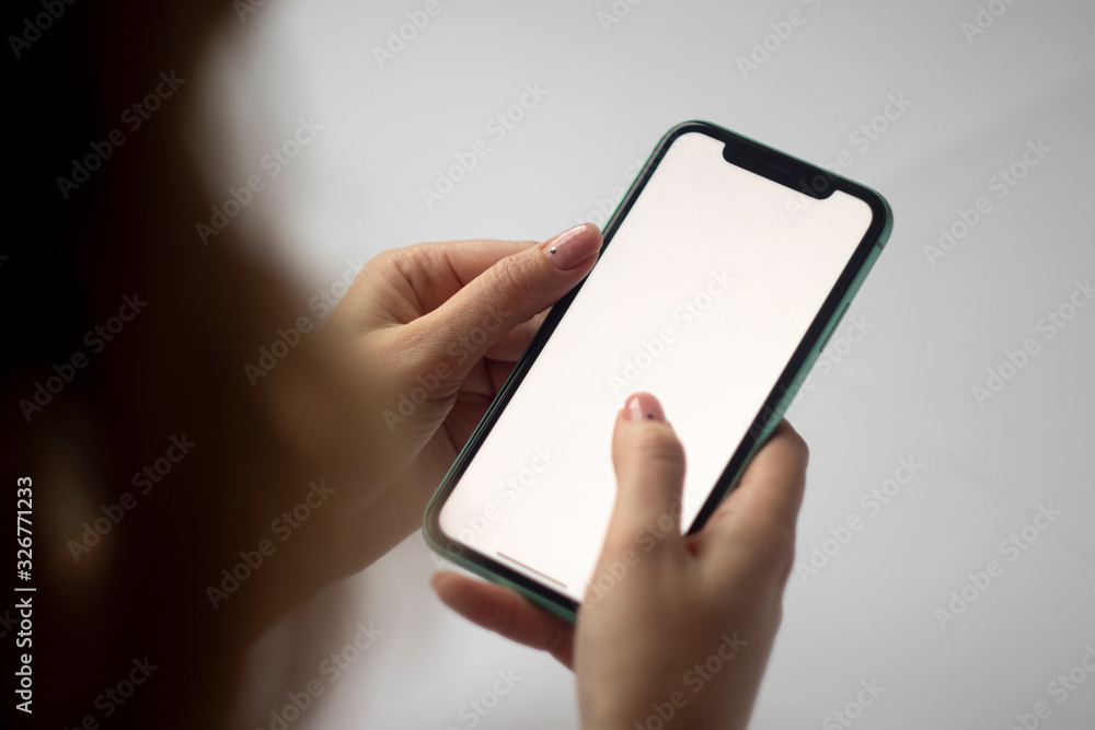 girl holds a mobile phone in a blank screen