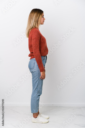 Full body young caucasian woman gazing left, sideways pose. photo