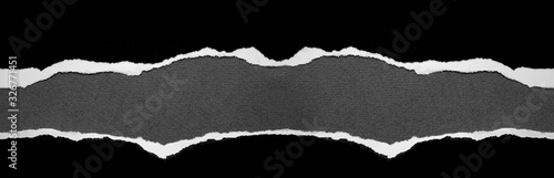 Ripped black paper on grey wide banner background
