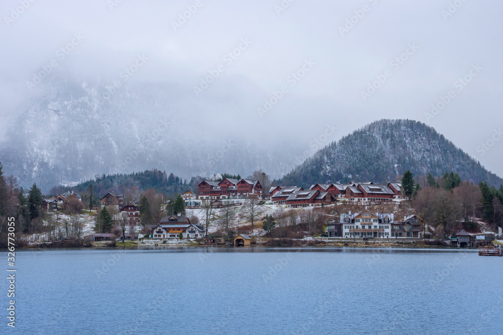 Small picturesque austrian village and Grundlsee, the largest lake in Styria, Austria, set in the wonderful mountain landscape, in misty winter morning Small picturesque austrian village and Grundlsee, the largest lake in Styria, Austria, set in the wonderful mountain landscape, in misty winter morning