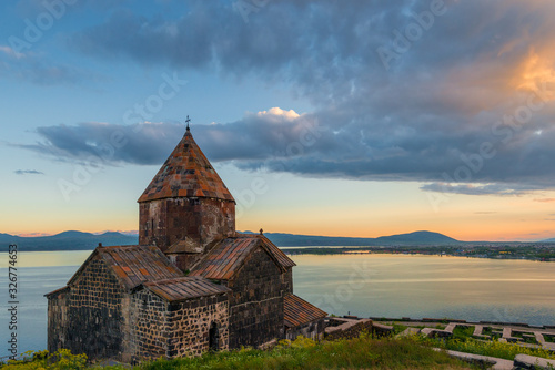 Black clouds at sunset, dramatic sky, view of Sevanavank Monastery and Lake Sevan, Armenia