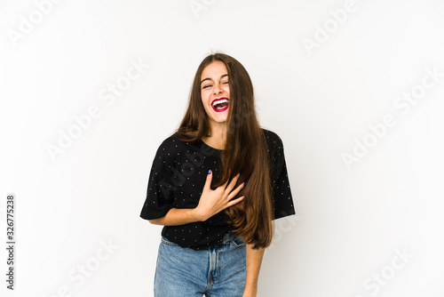 Young caucasian woman isolated on white background laughs out loudly keeping hand on chest.