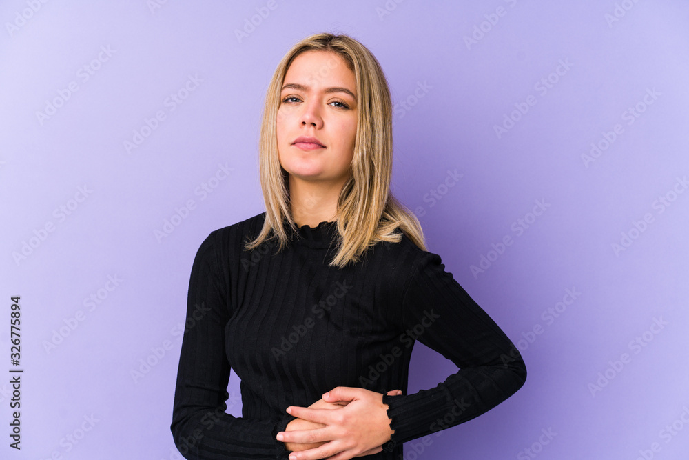 Young blonde caucasian woman isolated having a liver pain, stomach ache. Young blonde caucasian woman isolated having a liver pain, stomach ache.