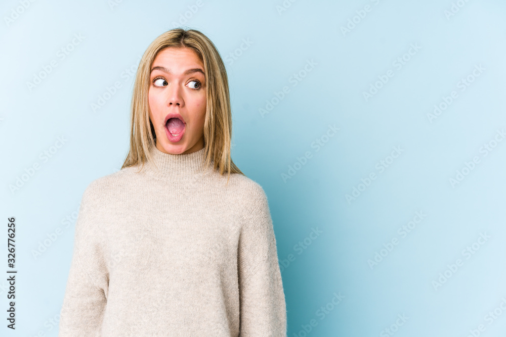 Young blonde caucasian woman isolated being shocked because of something she has seen. Young blonde caucasian woman isolated being shocked because of something she has seen.