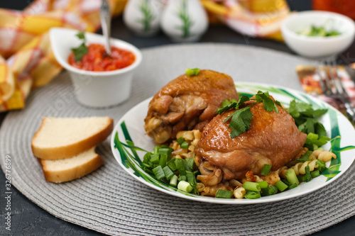 Chicken thighs with spices, soy sauce, green onion and side dish