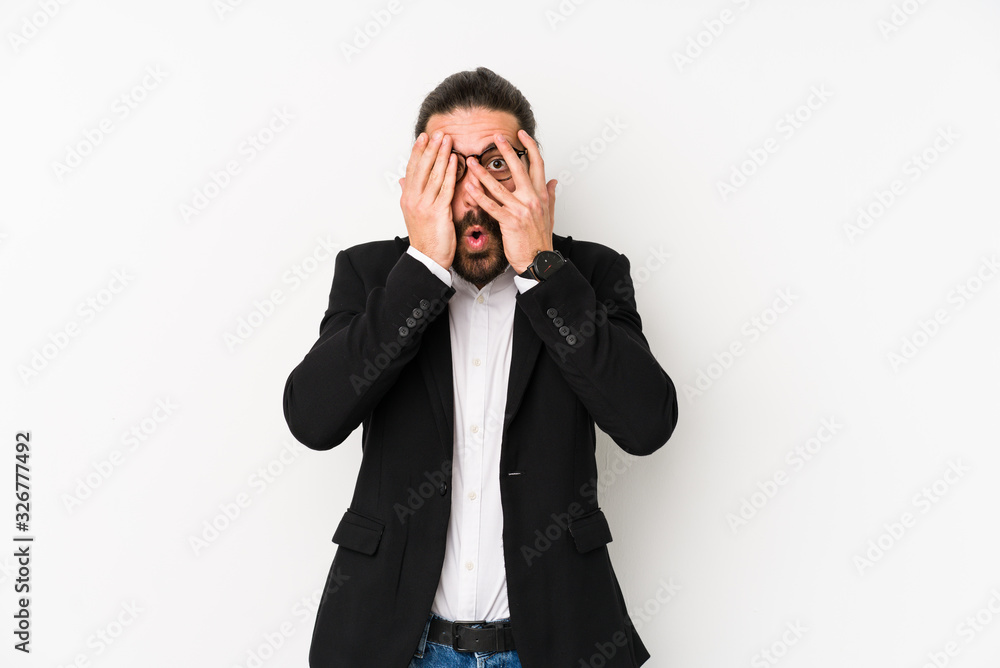 Young caucasian business man isolated on a white background blink through fingers frightened and nervous. Young caucasian business man isolated on a white background blink through fingers frightened and nervous.