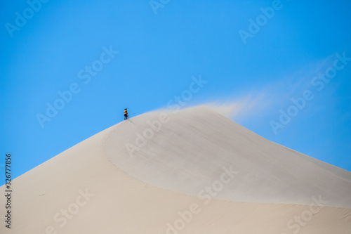 climbing the dune. singing dune in kazakhstan