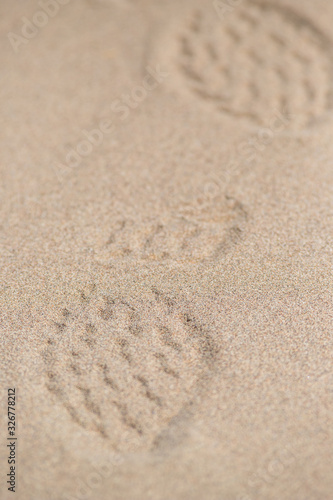 footprint in the sand. traces of shoes on. sand texture