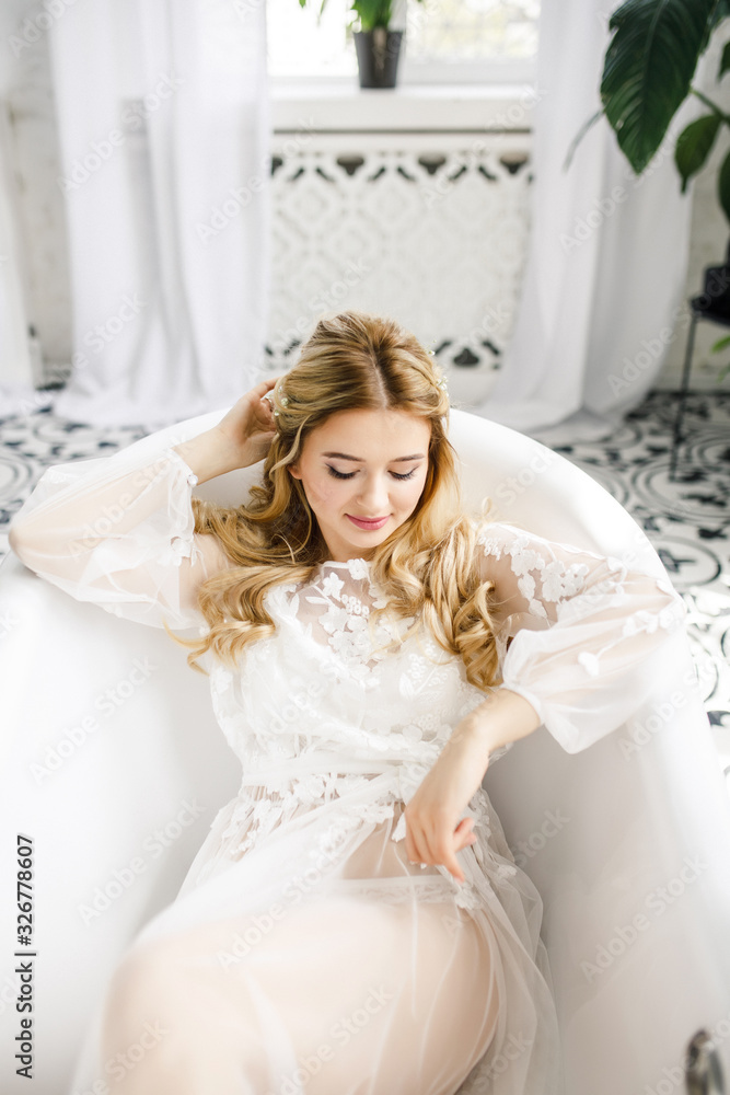 portrait of a young beautiful blonde bride in a beautiful dress in the bathroom portrait of a young beautiful blonde bride in a beautiful dress in the bathroom