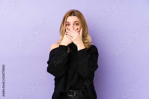 Young blonde woman isolated shocked covering mouth with hands.