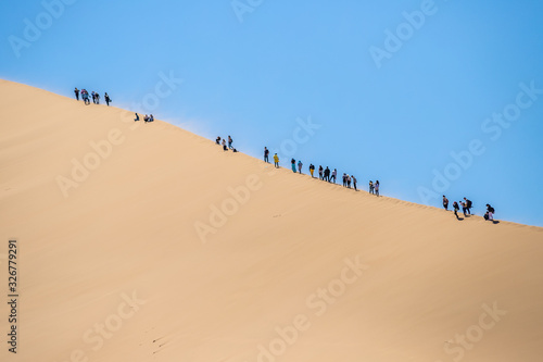 climbing the dune. singing dune in kazakhstan