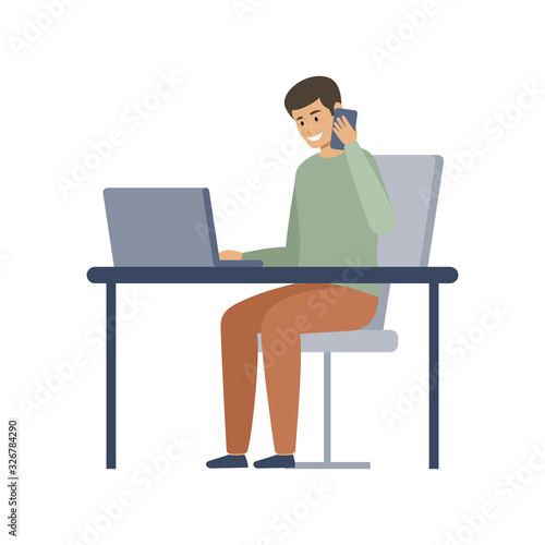 Male manager is working on a computer and talking on the phone