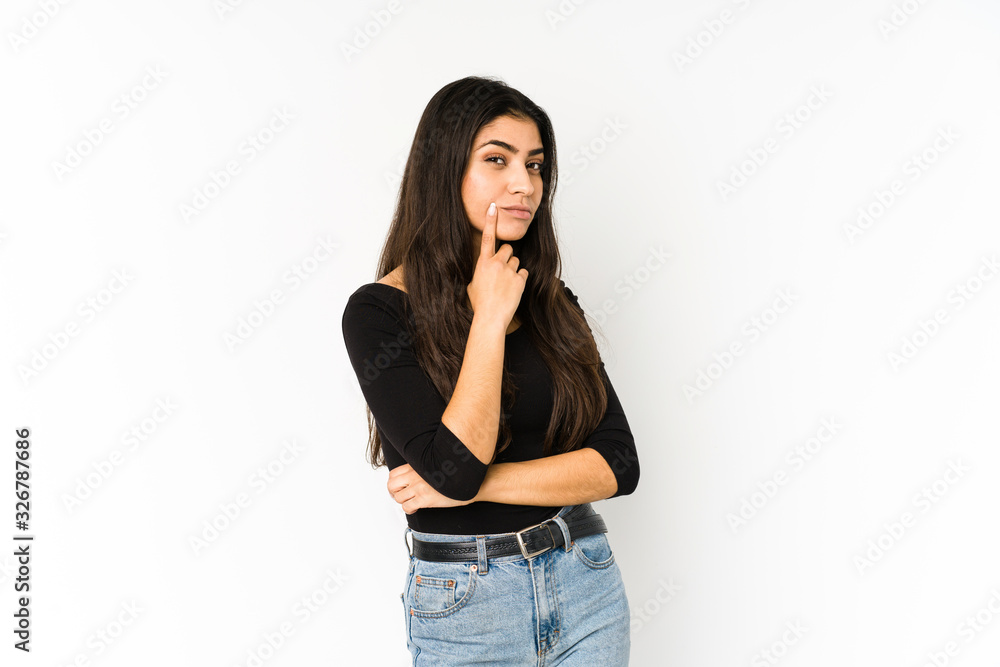 Young indian woman isolated on purple background contemplating, planning a strategy, thinking about the way of a business. Young indian woman isolated on purple background contemplating, planning a strategy, thinking about the way of a business.