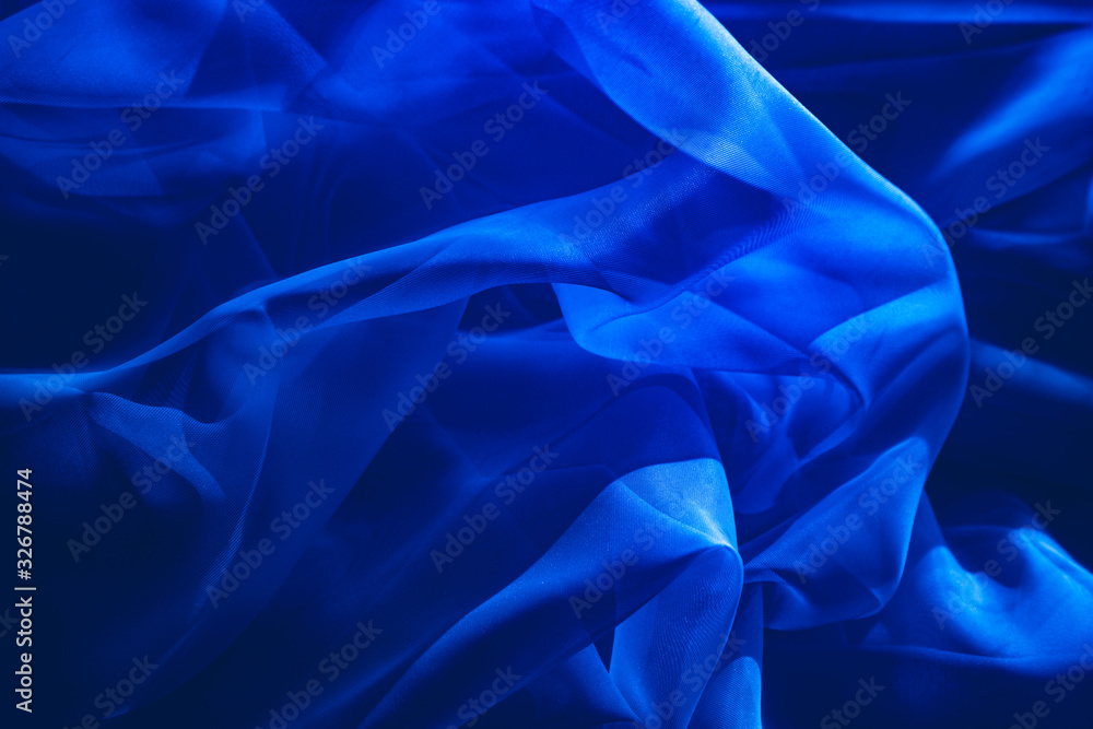 Obraz premium background image of a blue light translucent fabric with pleats. the view from the top.