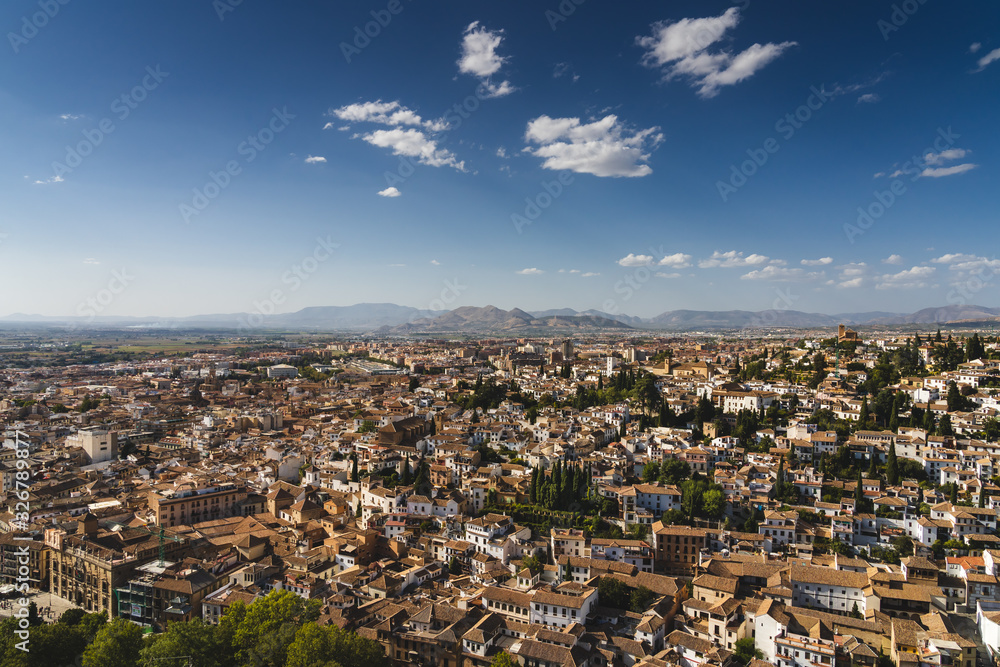 Beautiful view of the northwestern part of Granada city with the blue sky and the hills in the background, Andalusia, Spain. 