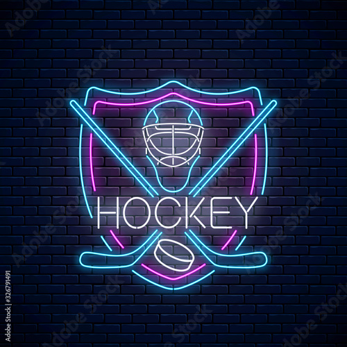 Hockey championship neon sign with hockey sticks, puck and goalkeeper helmet in shield frame. Ice hockey competition logo, emblem, symbol design. Vector illustration.