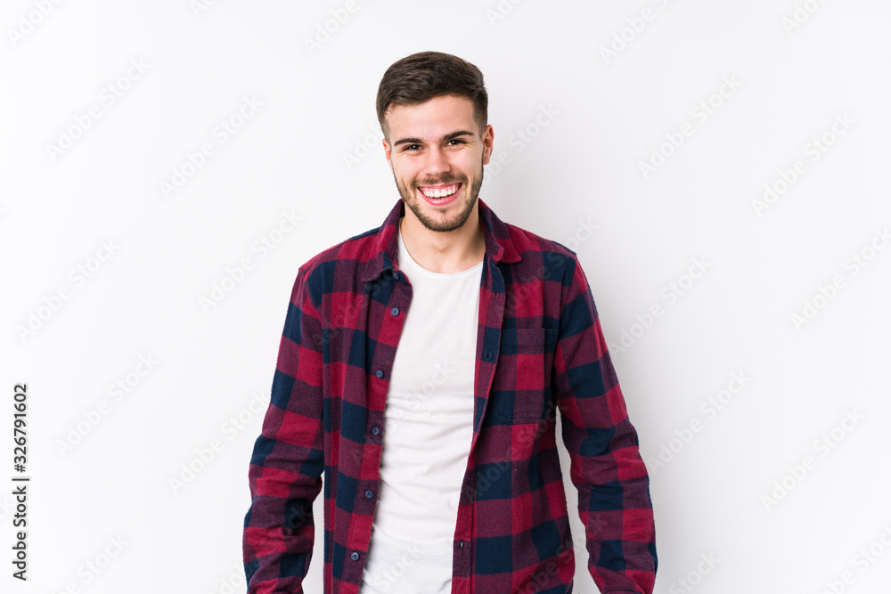 Young caucasian man posing in a white background isolated joyful laughing a lot. Happiness concept. Young caucasian man posing in a white background isolated joyful laughing a lot. Happiness concept.