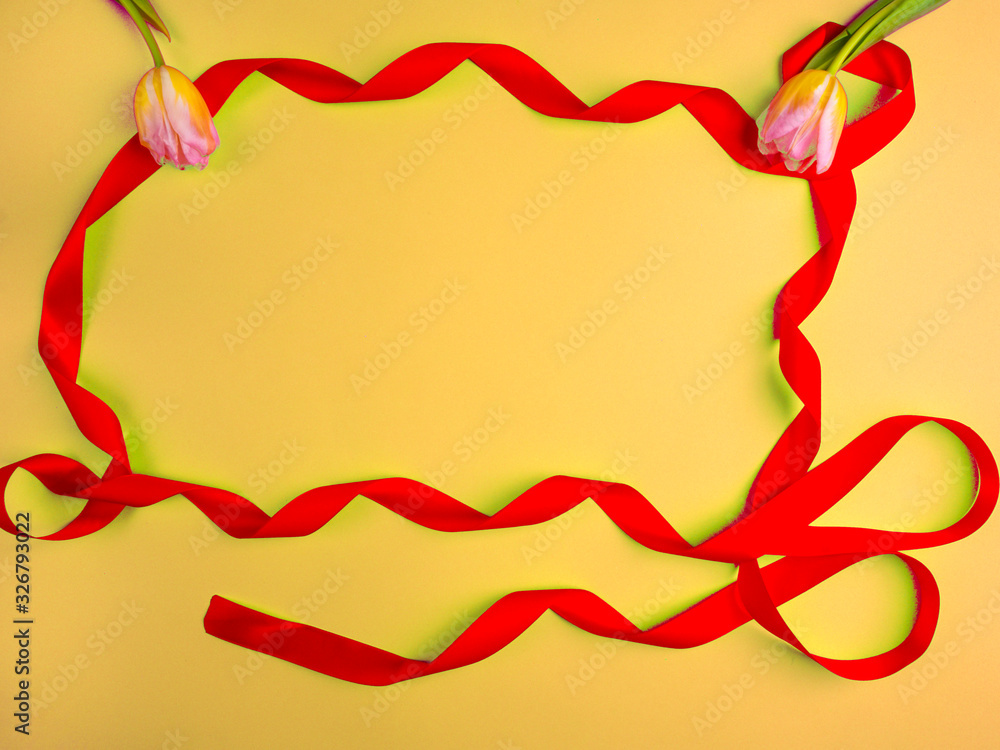 holiday curly tape and tulips on yellow background holiday curly tape and tulips on yellow background