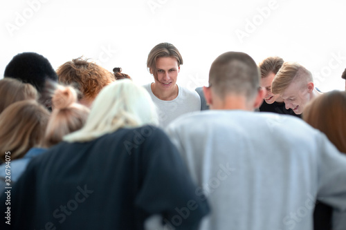team of young people makes a decision standing in a circle