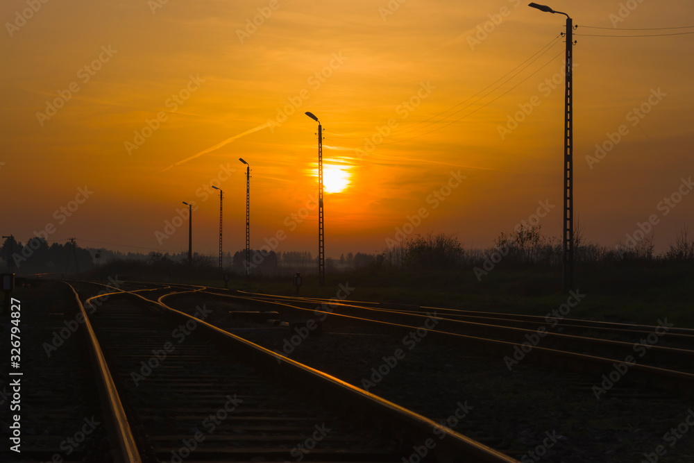Railroad tracks glistening in the light of the setting sun, transport, view, landscape