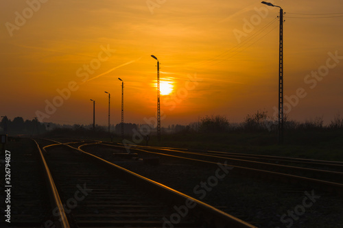 Railroad tracks glistening in the light of the setting sun, transport, view, landscape