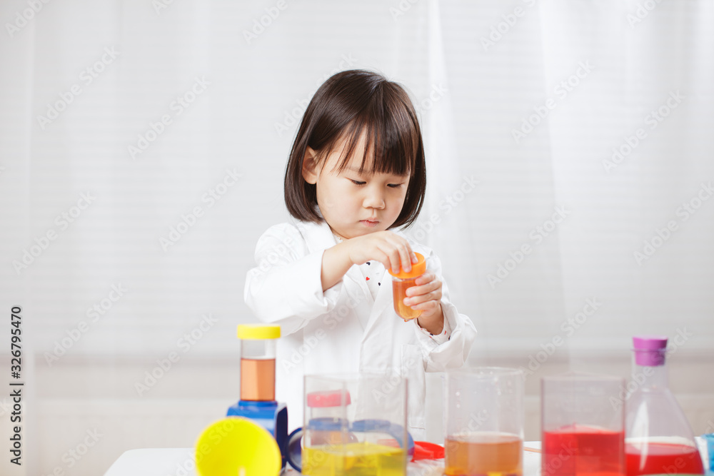 toddler girl pretend play scientist role at home against white background toddler girl pretend play scientist role at home against white background