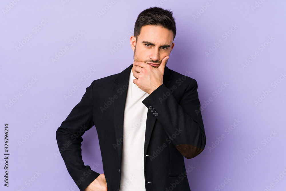 Young caucasian man isolated on purple background contemplating, planning a strategy, thinking about the way of a business. Young caucasian man isolated on purple background contemplating, planning a strategy, thinking about the way of a business.