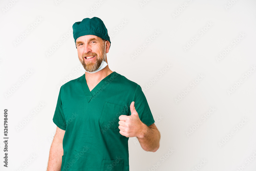 Surgeon senior man isolated on white background smiling and raising thumb up