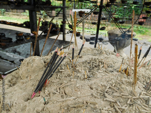 Smoldering incense sticks in a sacred place, Kandy, Sri Lanka.