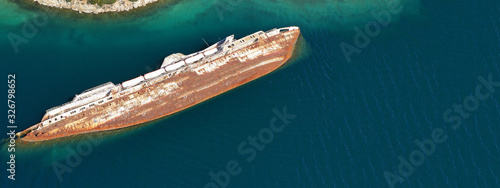 Aerial drone ultra wide photo of shipwreck passenger ship left to sink and rust near shore
