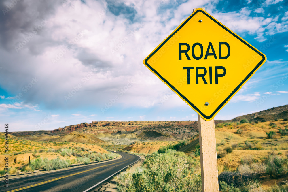 Road Trip street sign on deserted scenic summer desert highway 