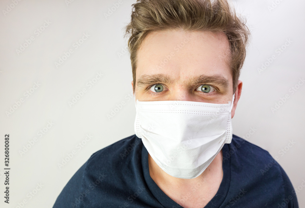 Man with mask to protect him from virus. The concept of the epidemic of the coronavirus. Tired Doctor with medical white mask. Man with mask to protect him from virus. The concept of the epidemic of the coronavirus. Tired Doctor with medical white mask.