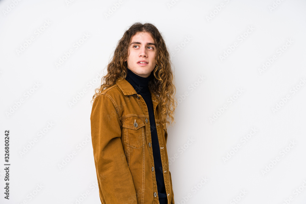 Long hair man posing isolated looks aside smiling, cheerful and pleasant. Long hair man posing isolated looks aside smiling, cheerful and pleasant.