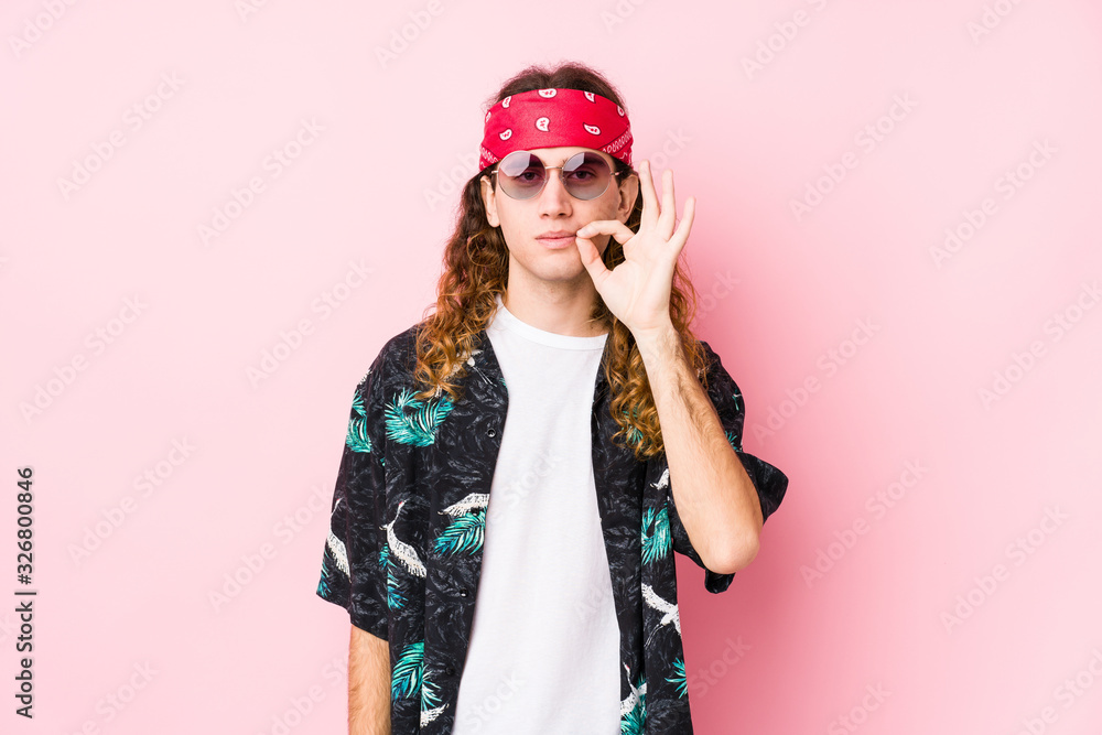 Young hippie caucasian man isolated with fingers on lips keeping a secret.