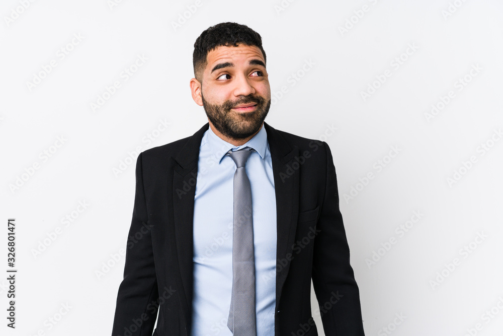 Young latin business woman against a white background isolated dreaming of achieving goals and purposes Young latin business woman against a white background isolated dreaming of achieving goals and purposes