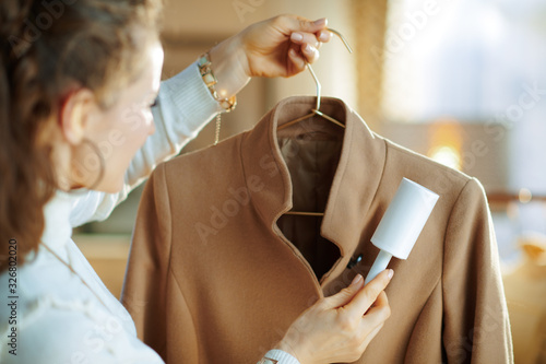 Принти на полотні trendy housewife cleaning coat on hanger with lint roller