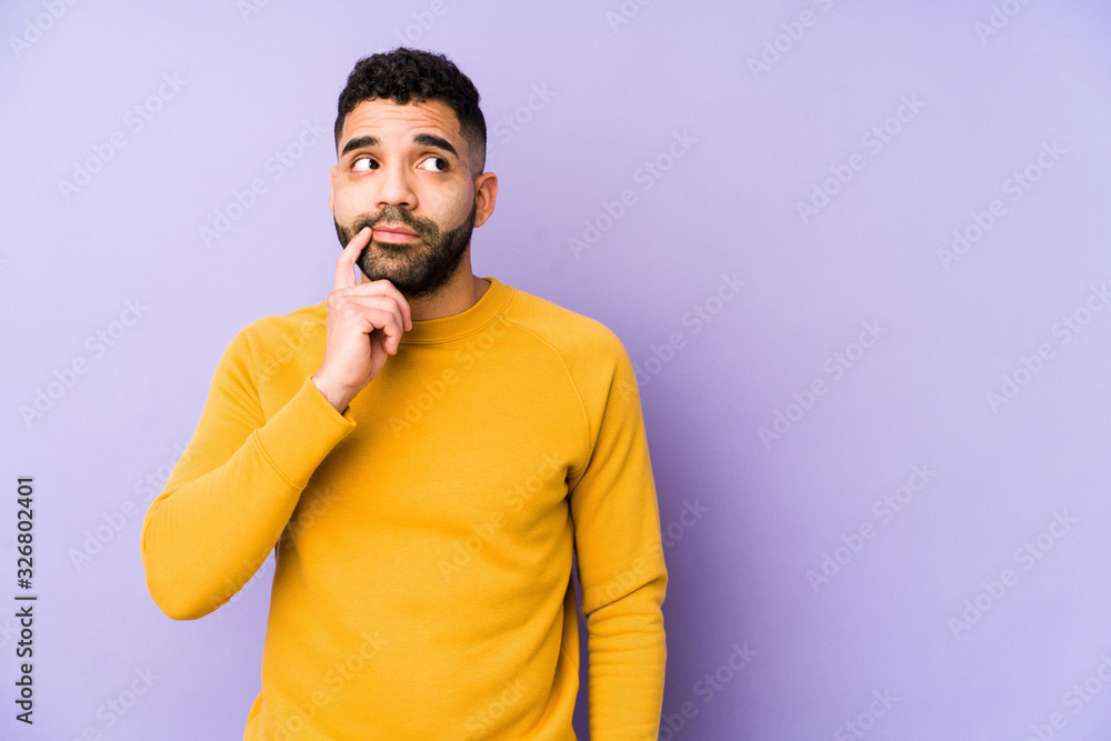 Young mixed race arabic man isolated looking sideways with doubtful and skeptical expression.