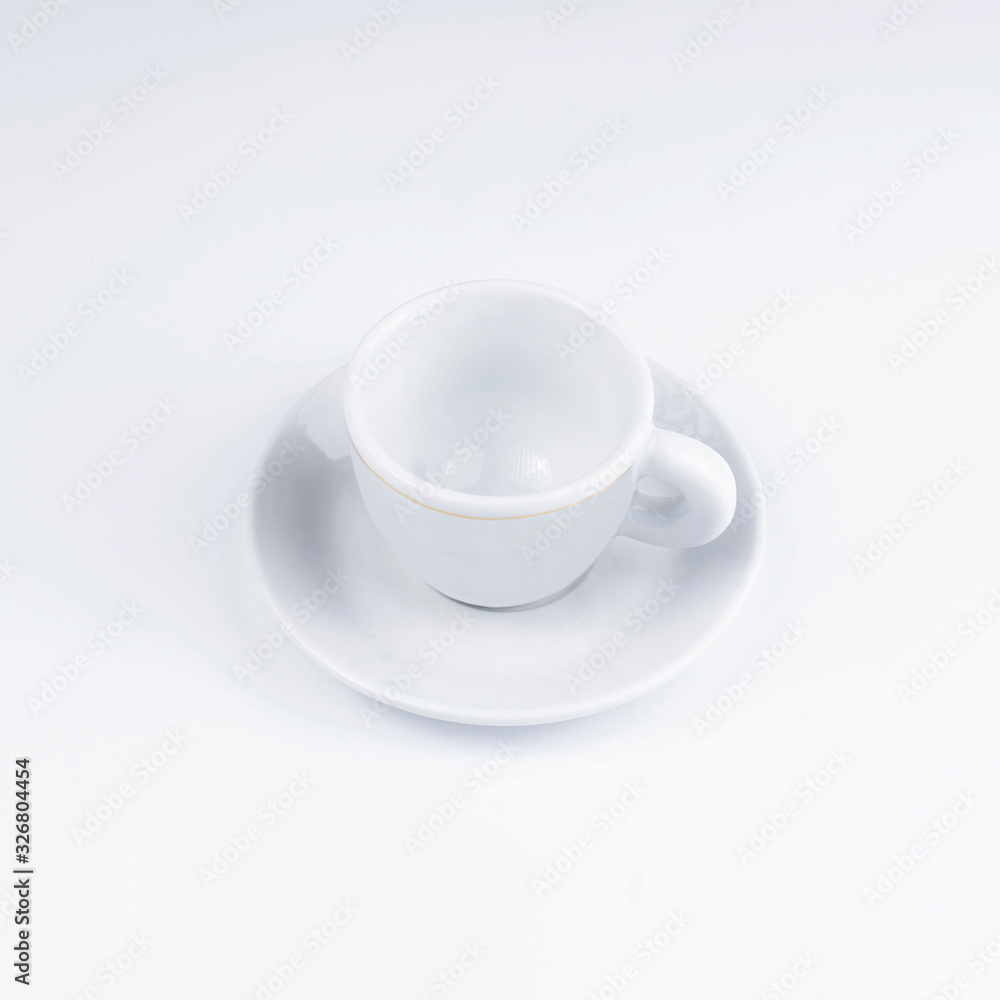 Small white coffee cup on a white background. Small white coffee cup on a white background.