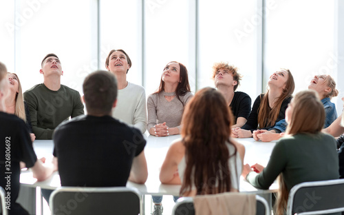 focused group of young people sitting at a round table