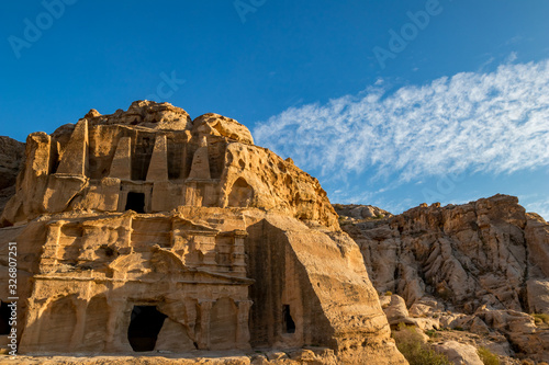 Petra  Jordan. Setting sun light over the Obelisk Tomb or Bab As Siq Triclinium in the beautiful Middle East kingdom. Beautiful clouds in the blue sky warm winter day afternoon