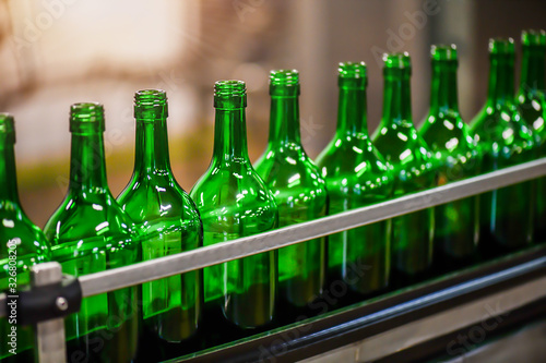 Bottling and conveyor line or belt at winery factory  Wine bottles filling production.
