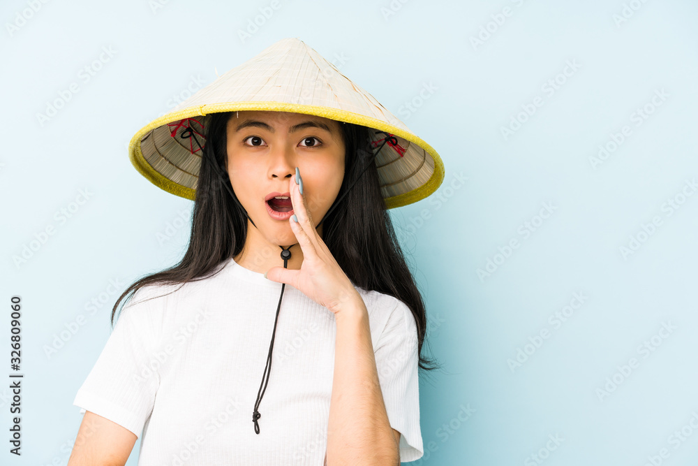 Young chinese woman wearing a vietnamese hay isolated pointing temple with finger, thinking, focused on a task.
