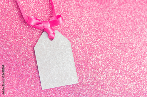 Blank tag tied with pink ribbon. Price tag, gift tag, sale tag, address label.