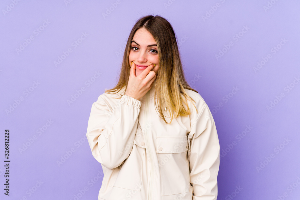 Young caucasian woman isolated on purple background doubting between two options. Young caucasian woman isolated on purple background doubting between two options.