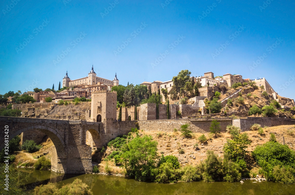 Panoramic view of  Alcazar and Alcantara Bridge in the city Toledo, Spain.
