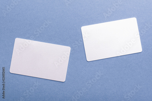 two blank cards on a blue background with copy space. stickers note for design close-up, top view.
