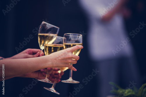 Cheers! Group of people cheering with champagne flutes with party background, Concept Celebration.